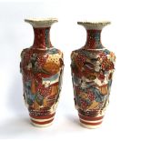 A pair of Japanese satsuma vases, with decorative moulded knot and tassel handles, heightened in