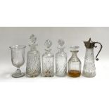 A lot of four various cut glass decanters together with a claret jug and a large goblet