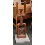 A carved wood abstract figure, on stone base, approx. 83cmH