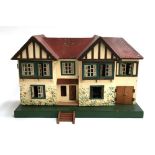 A Triang wooden dolls house; together with some furniture