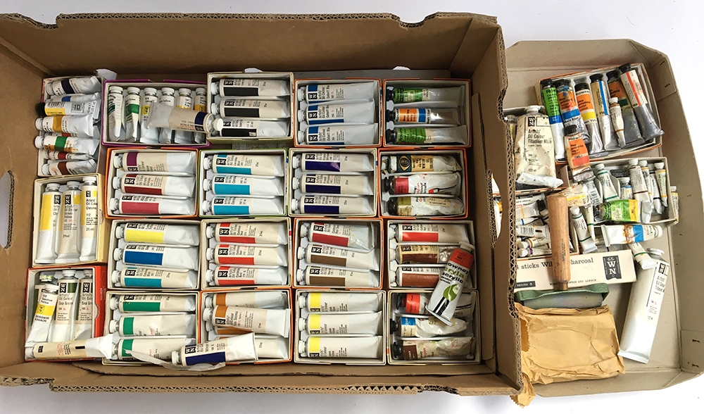 A large box of various Winsor and Newton and Rowney oil paints, with a metal easel
