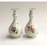 A pair of Meissen bottle vases, hand painted floral and insect decoration, one af, blue underglaze