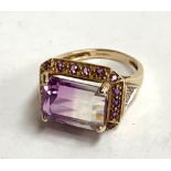 9ct gold dress ring with purple stones , gross weight 5g.