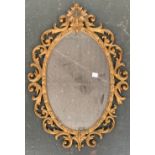 A modern oval wall mirror in gold scrolling frame, 62cmH