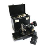 An Electric Singer sewing machine no. 221K1, in hard carry case, with removable tray