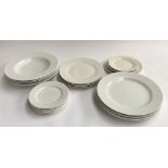 A collection of white china plates, including a set of 16 by Heals and others