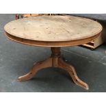 A circular pine tip top table on turned column tripod base, approx. 120x74cmH