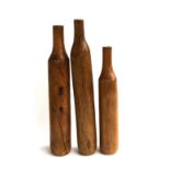 A set of three teak candle holders in the form of bottles, the tallest approx. 55cmH