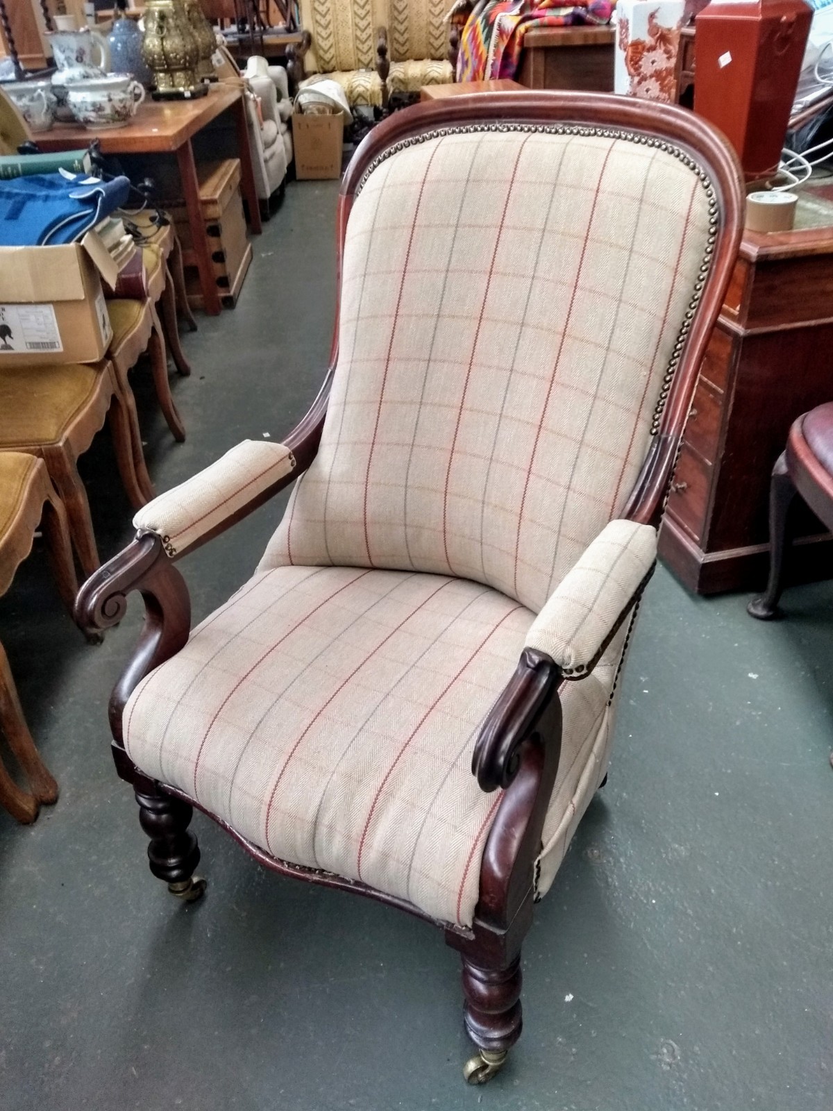 A 19th century mahogany salon chair, recently re-upholstered, on turned legs and casters