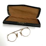 A pair of pince nez glasses in yellow metal
