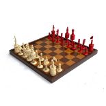 A 19th century bone chess set, natural and red stained, the king 9.5cm high, the queen 10cm;