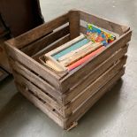 A vintage apple crate; together with a number of children's annuals from the 50s-70s