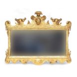 A 19th century Continental giltwood carved mirror, with acanthus and cherub cresting, 89cm x 110cm
