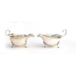 A near pair of silver sauce boats by George Nathan & Ridley Hayes, Chester 1915 and Adie Brothers