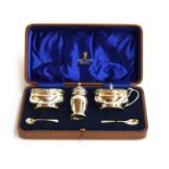 A cased silver cruet set by Adie Brothers Ltd, Birmingham 1938, retailed by John Bagshaw, comprising