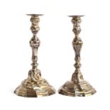 A matched pair of French silver candlesticks, of wrythen baluster form, each on shaped base, the one