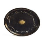 A 19th century ebonised papier mache tray, with mother of pearl inlay border surrounding a scene