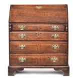 A George I/II oak bureau, fall front over four graduating drawers, on bracket feet, 83cm wide,