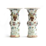 A pair of 18th century Chinese famille rose gu vases, with moulded and applied floral and '