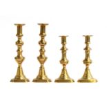 Two pairs of Regency brass candlesticks, 29.5cm and 23.5cm high