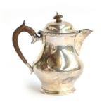 A George V silver coffee pot, by Edward Barnard & Sons Ltd, London 1935, carved wood knop and