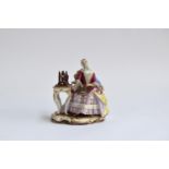 A 19th century Meissen group of a seated lady at a spinning wheel, 'The Good Housekeeper' or '