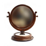 A Victorian circular mahogany adjustable shaving mirror, on a marble and turned wooden plinth