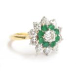 An 18ct gold diamond and emerald cluster ring, approximately 1 carat of diamonds comprising of 1