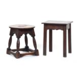 Two Georgian oak stools, one circular on four turned splayed legs and peripheral stretcher, the