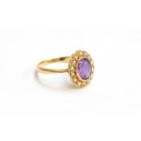 An 18ct gold seed pearl and amethyst ring, gross weight 3.8g, size M