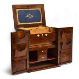 A Victorian walnut desk stationery cabinet, the bevelled hinged top with a leather inset panel on