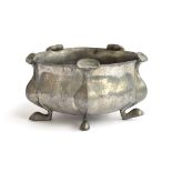 A Liberty & Co. Tudric Arts and Crafts hammered pewter bowl on five pad feet, designed by Oliver