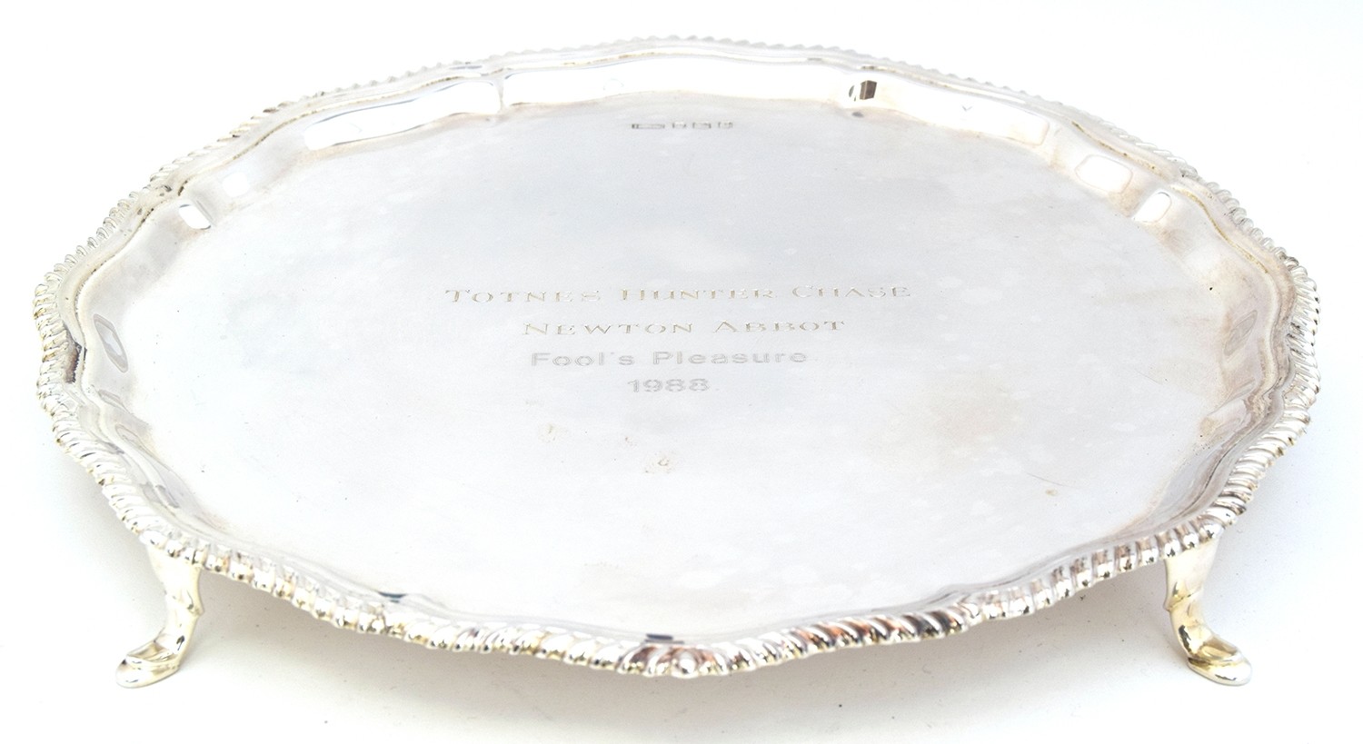 A silver salver with gadrooned edge, Sheffield 1960, raised on four hoof feet, 16.4oz