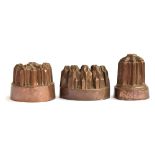 A tall Victorian copper jelly mould, marked MCM, 14.5cm high; together with two others (3)
