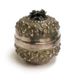 A Continental 900 silver lidded pot, chased with flowers and foliage, approximately 12cm high, 9.4oz