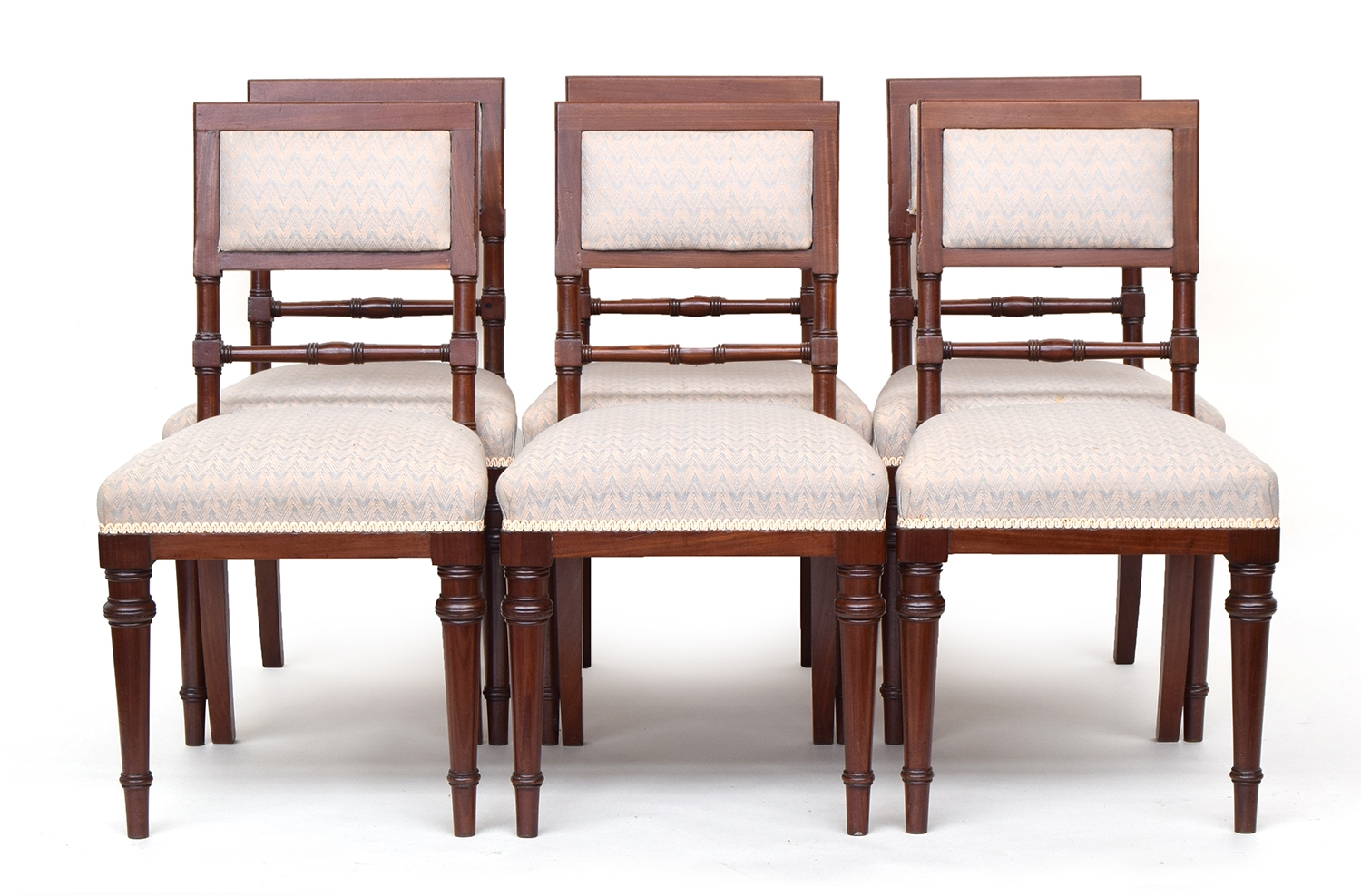 A set of six mahogany dining chairs, possibly military, each frame bearing the Broad Arrow impressio