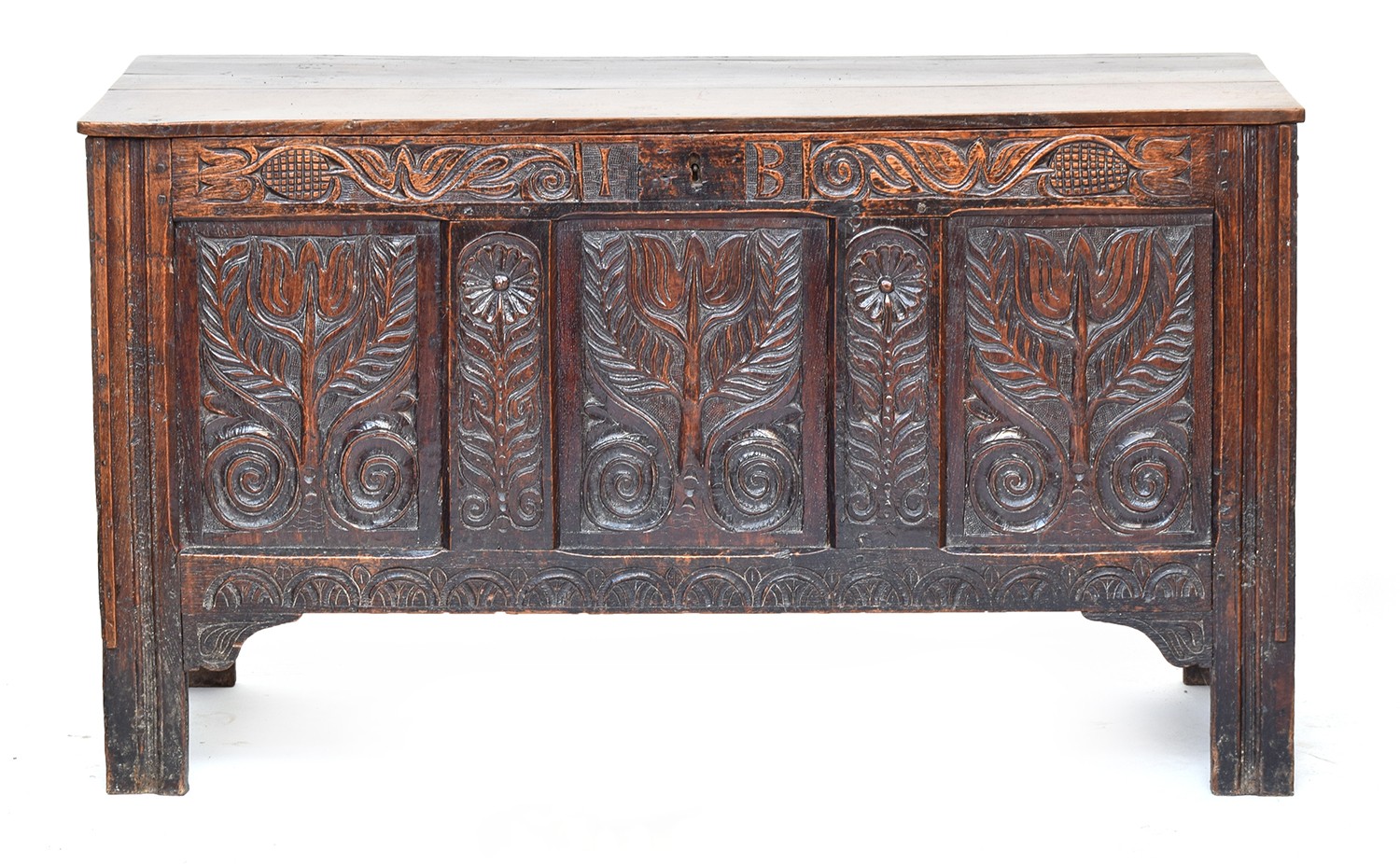 A 17th century three panel oak coffer, the front initialled 'I B' and carved with floral motifs,