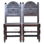 A pair of Charles II style hall chairs, carved back over solid seats, joined on turned peripheral