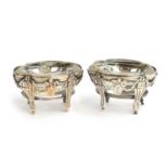 A pair of white metal Neo-classical salts, each with heavy glass liner, chased with bows and