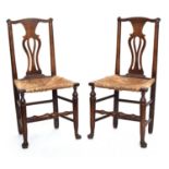 A pair of oak splat back chairs with rush seats