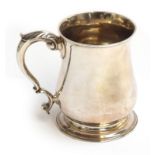 A George II baluster mug with a spreading circular foot and scroll handle, by Richard Gosling,