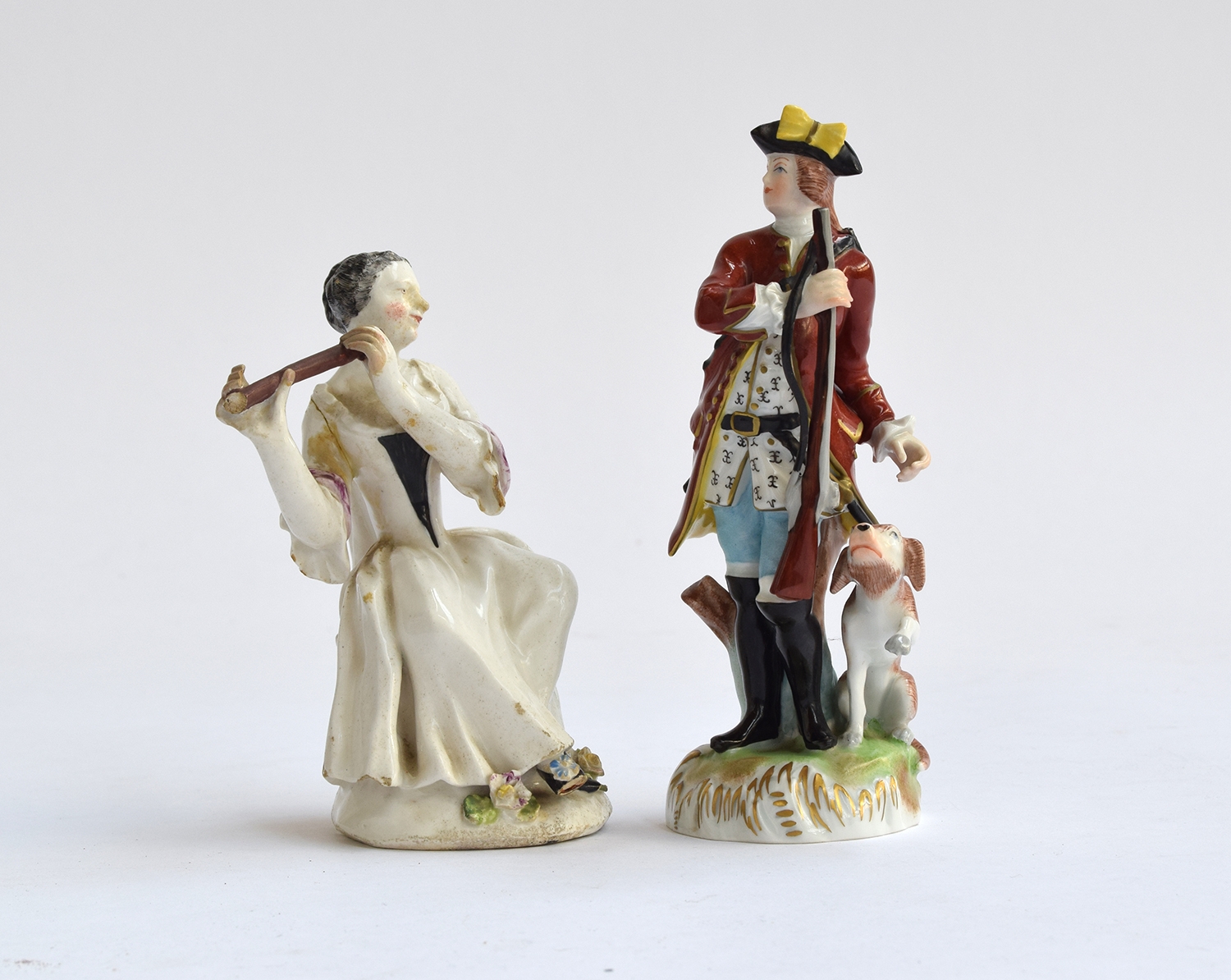 A Dresden figure of a continental gentleman with rifle and dog, marked to base and stamped 6598,