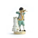 A late 19th century Meissen figure of a young boy in a turquoise coat aiming a crossbow beside a