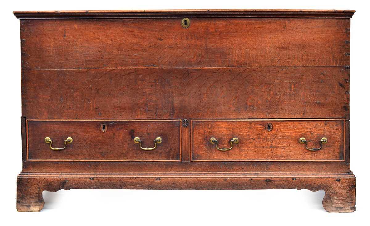 A Georgian oak mule chest, hinged lid with moulded edge, two cockbeaded drawers, on bracket feet