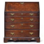 A George I/II oak bureau, fall front revealing a stepped fitted interior with drawers and