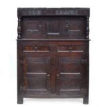 A small 17th century oak court cupboard, the upper section with two doors, flanked by turned