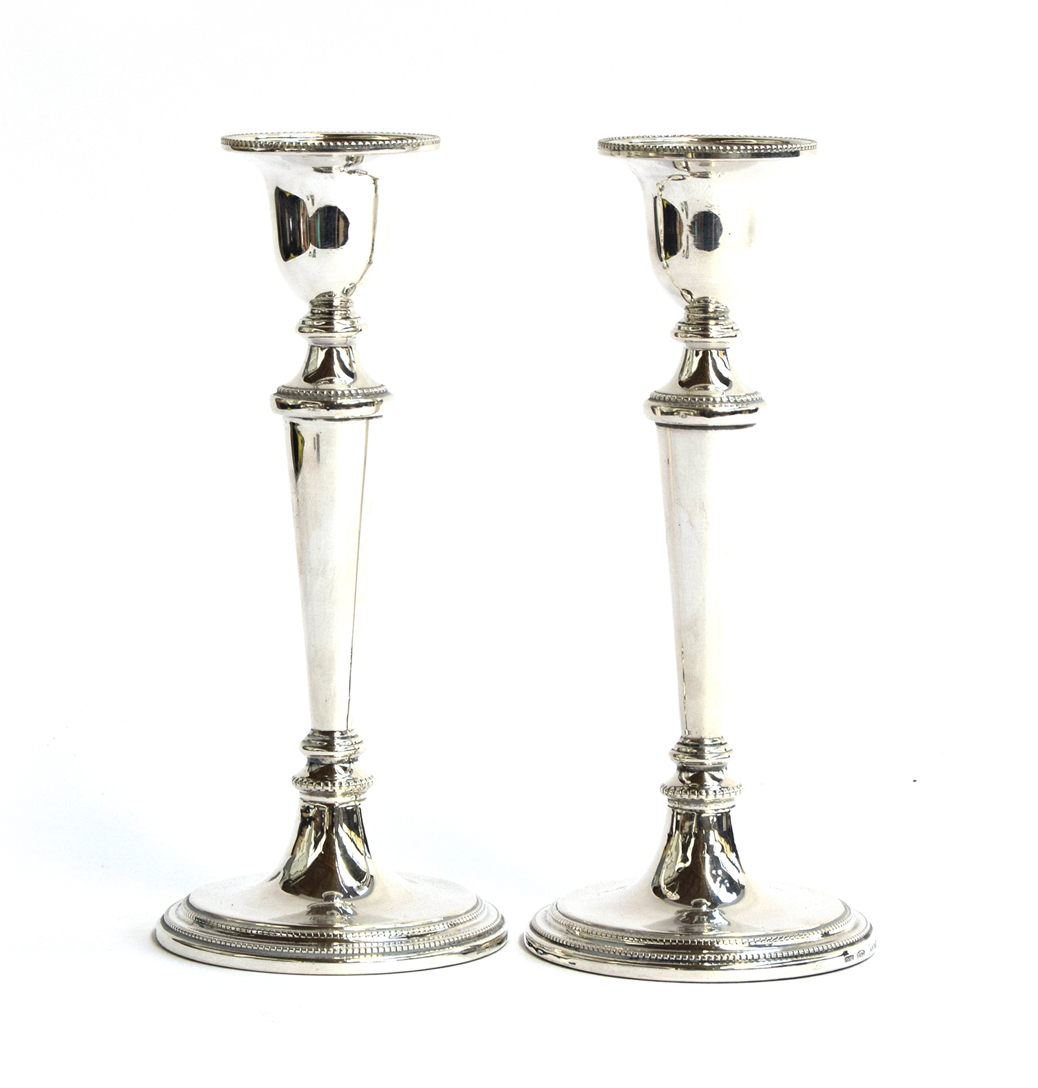 A pair of silver-filled candlesticks by W I Broadway & Co, Birmingham 1986, on tapering on circular