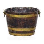 A George III coopered peat bucket, oval with twin brass lion mask handles, 42 wide, 32cm deep,