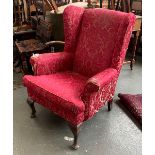 A 20th century wingback armchair, on cabriole legs