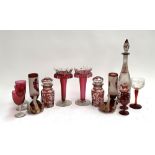 A collection of cranberry glass to include a pair of decanters; a pair of spill vases; a pair of